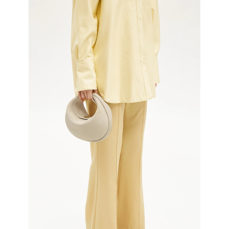 Half Moon Cowhide Leather Shoulder ivory color holding it as a top handling bag 2