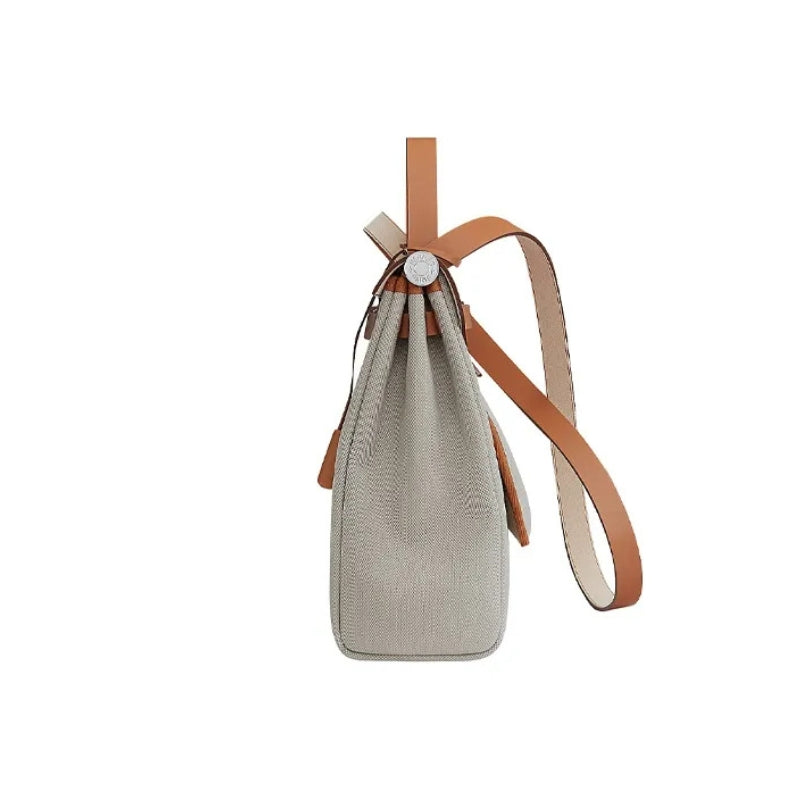 Women’s Canvas Lock Buckle Crossbody Top Handle Bag in color beaig form the side of the bag