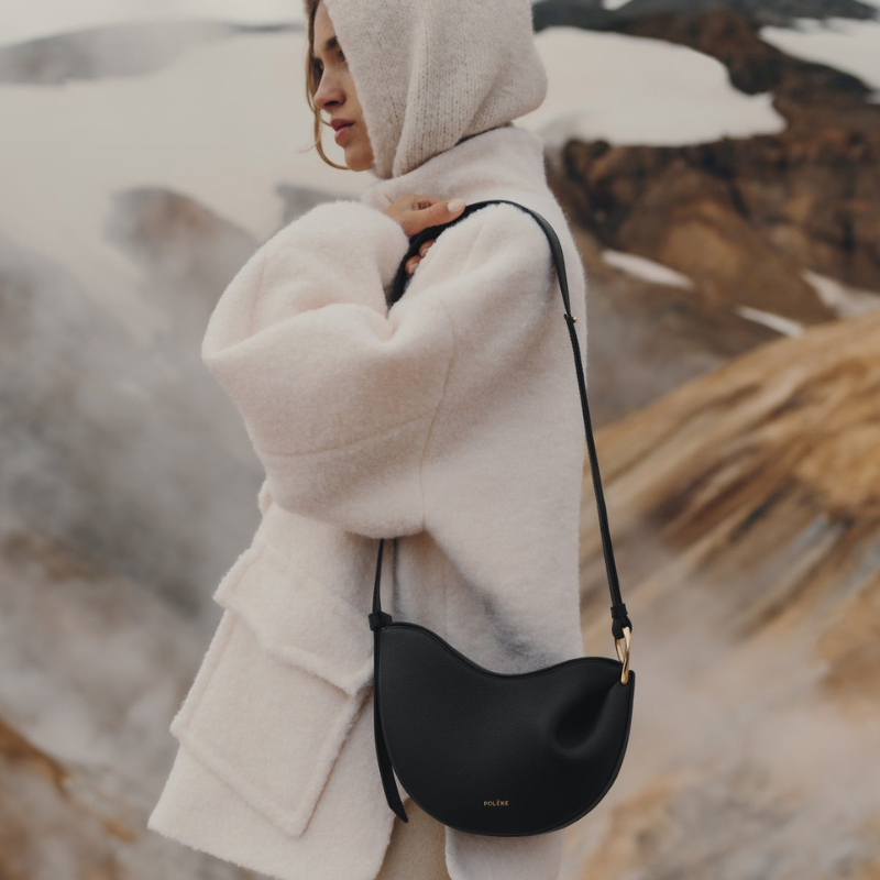 Black genuine leather crescent shoulder bag worn crossbody