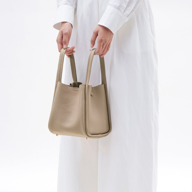 Genuine Leather Crossbody Bucket Bag cream apricot color Lifestyle model handling it