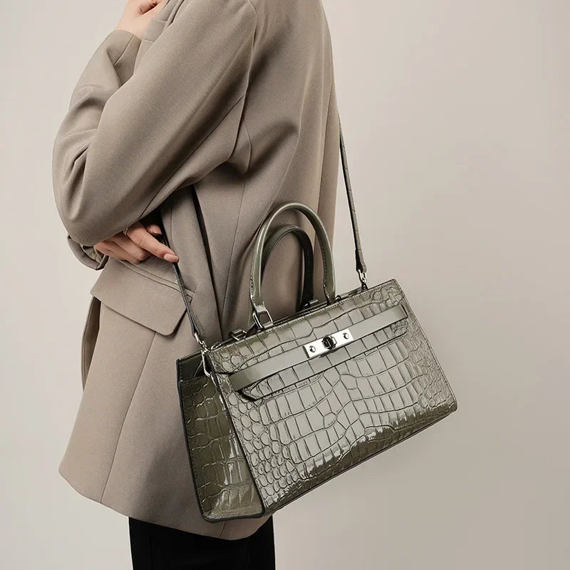 Gray Patent Crocodile Leather Lock Buckle Top Handle Crossbody Bag held as crossbody bag