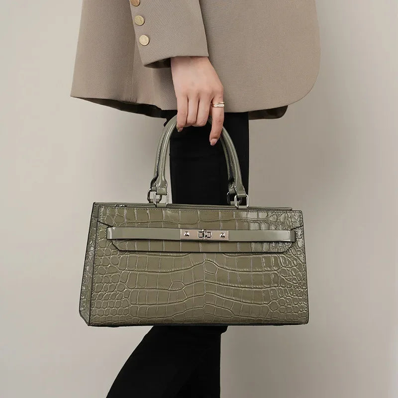 Gray Patent Crocodile Leather Lock Buckle Top Handle Crossbody Bag held as tote bag by model