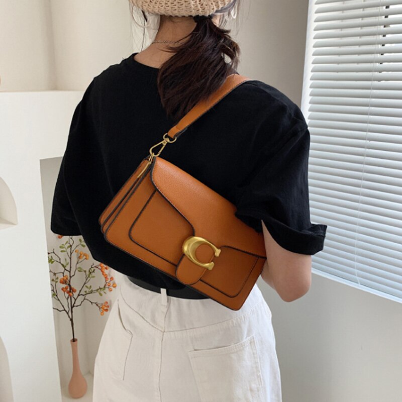 Leather Shoulder Crossbody Bag held by model in caramel color