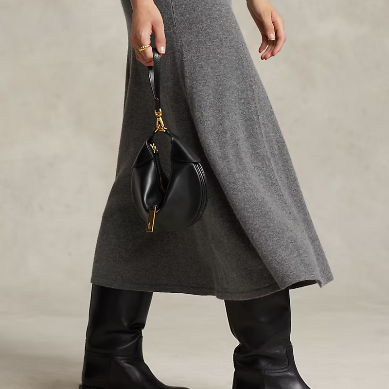Saddle Half Moon Shoulder Bag in Genuine Calfskin Leather in black color held by model as a tote bag