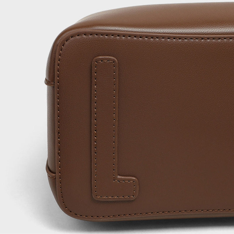 Small leather bucket bag side view, brown leather texture