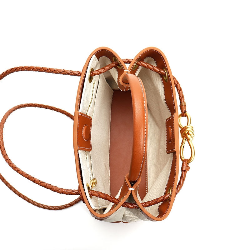 Structured leather trim canvas handbag with gold detail showing interior 