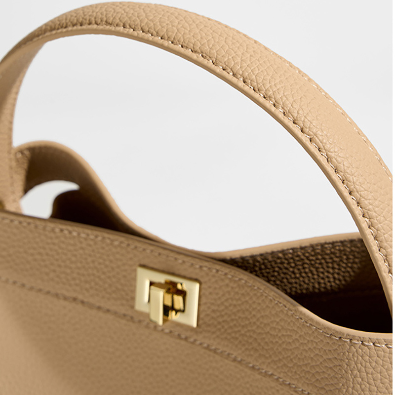 Women’s Genuine Leather Minimalist Lock Clasp Shoulder Bucket Bag in creamy white color showing details of the bag