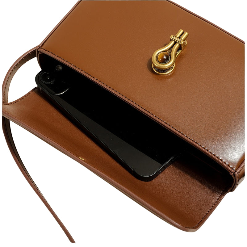 Women’s Genuine Leather Shoulder Baguette Bag with Gold-Tone Hardware in camel color from the front showing inside the bag