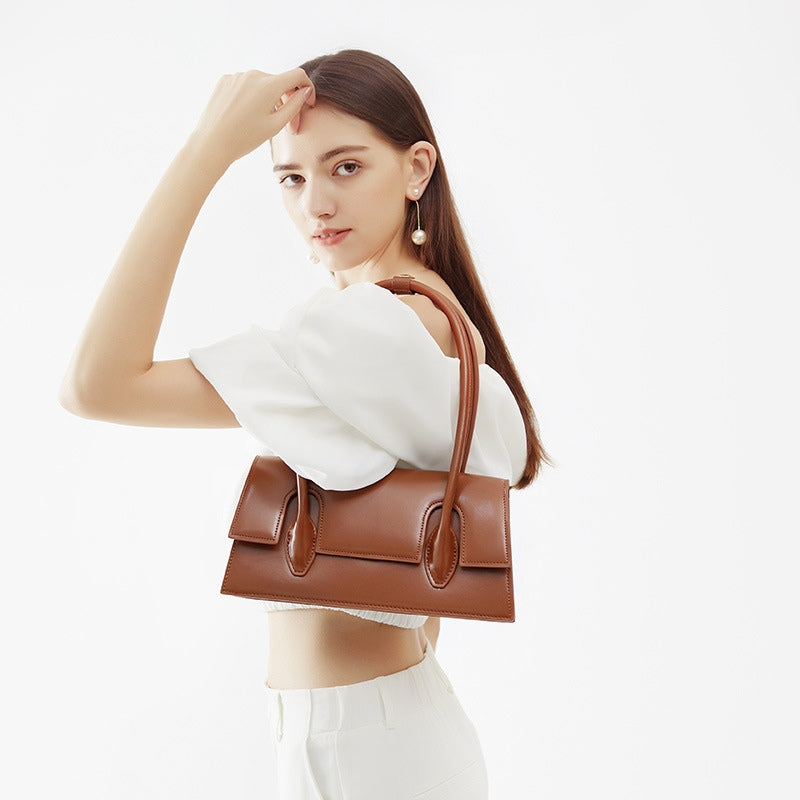 Women’s Minimalism Flap Baguette Bags in Genuine Leather in Cognac color model carry it as a shoulder bag