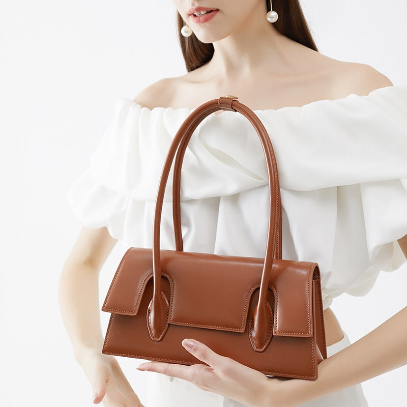 Women’s Minimalism Flap Baguette Bags in Genuine Leather in Cognac color model carry it on her hand