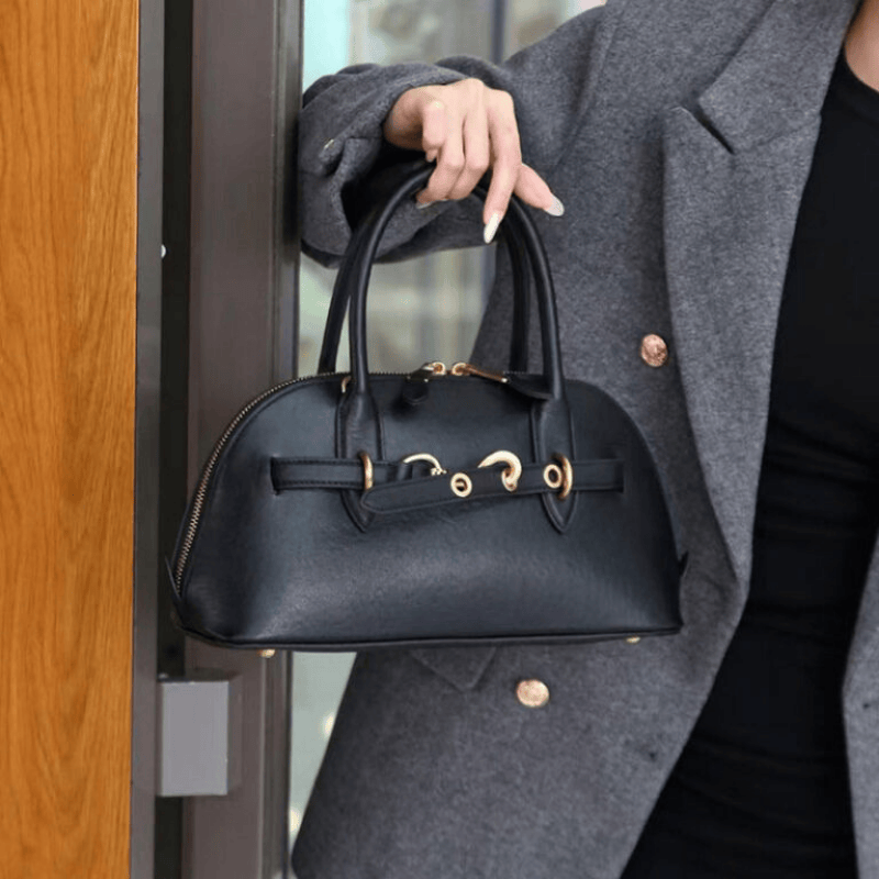 Women’s Vintage Genuine Leather Shell-Shaped Top Handle Bag in Black color held by model as a tote bag