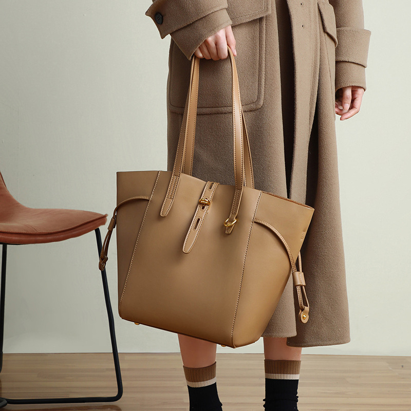 Women’s Vintage Large Genuine Leather Lock-Clasp Tote Bag in brown color lifestyle model handle it as a top handle bag