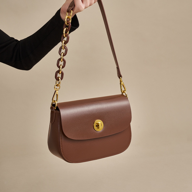 Women’s Vintage Minimalist Genuine Leather Lock Chain Crossbody Shoulder Bag in coffee color lifestyle model showing it from the front