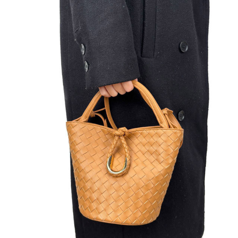 Woven leather bucket bag in camel — front view showing knot detail