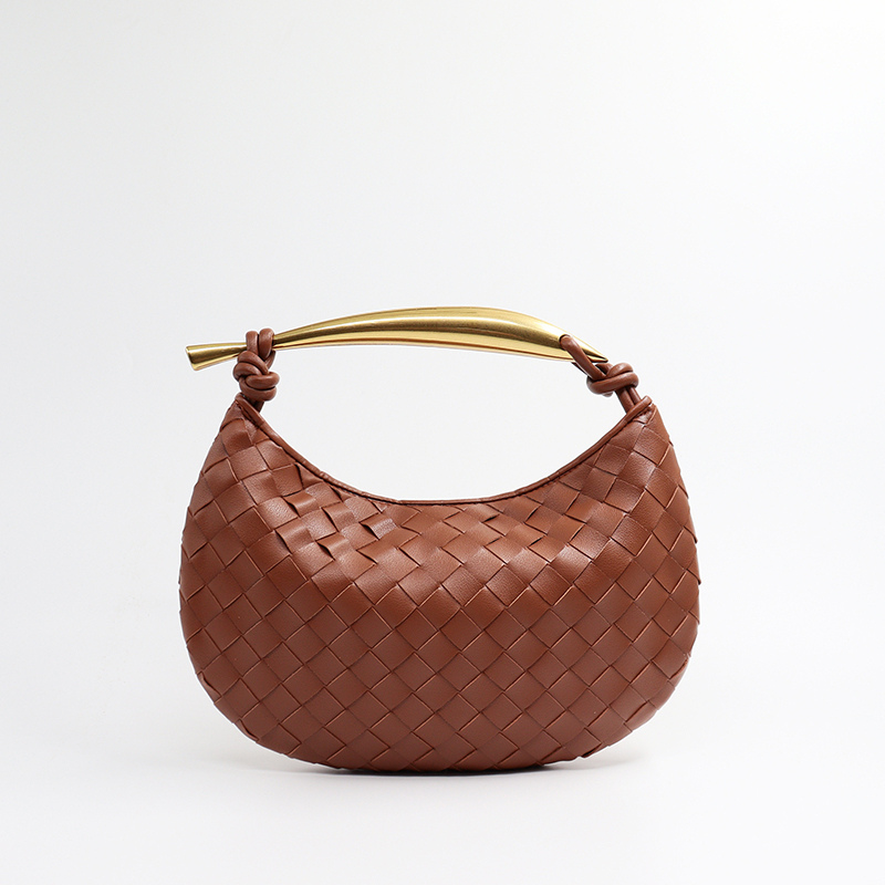 Woven leather half-moon bag in rust orange with gold curved handle