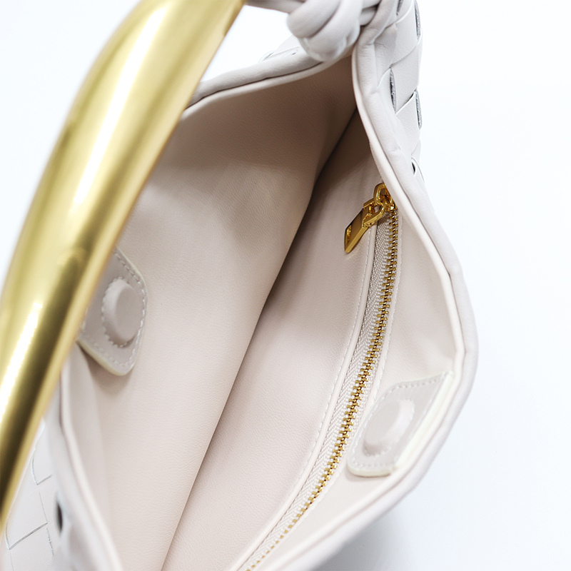Woven leather half-moon bag interior, cream lining, gold hardware