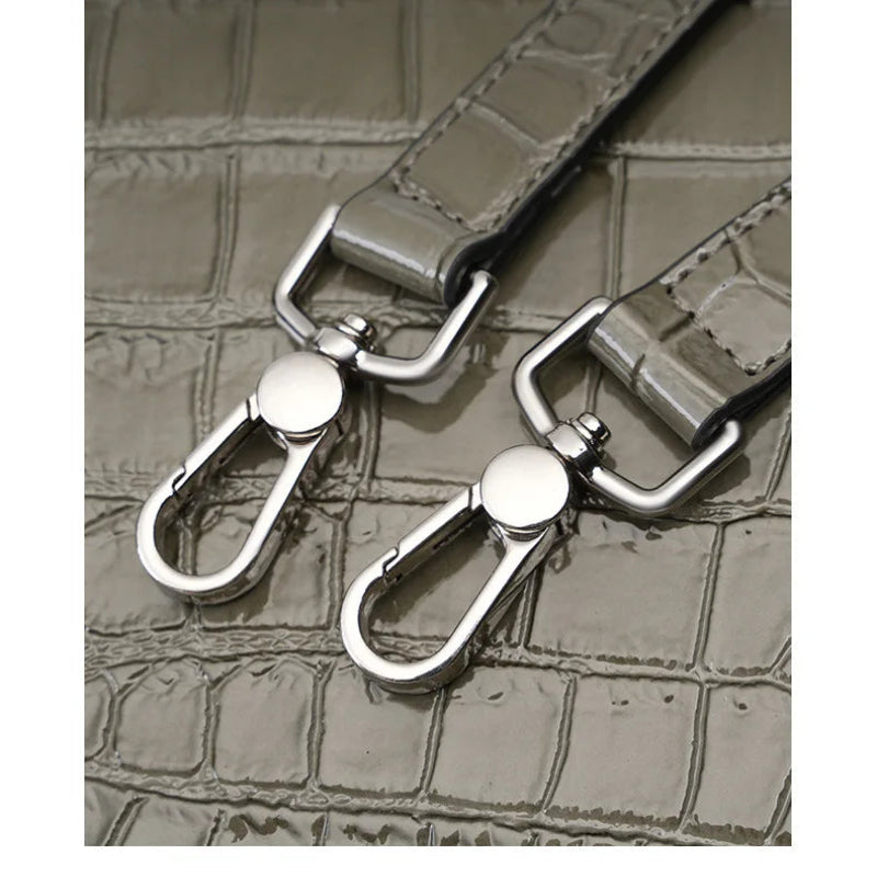 adjustable strap hooks detail structured leather handbag metal hardware close up