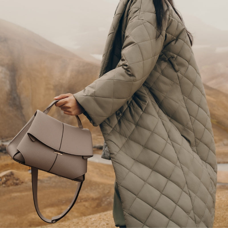 beige fold over leather bag styled with casual outfit outdoors