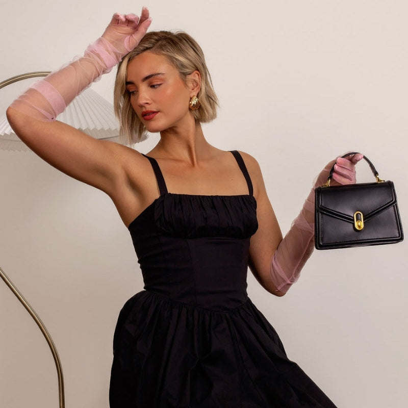black genuine leather top handle bag with gold closure structured minimalist handbag