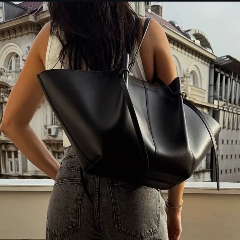 black slouchy leather tote bag worn on shoulder everyday outfit style