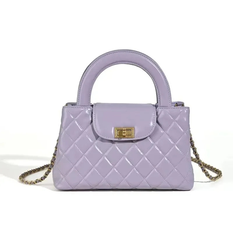 compact quilted top handle bag in purple with structured shape