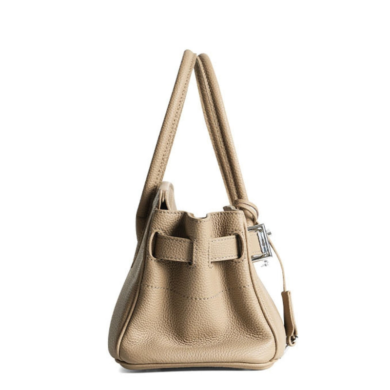 leather handbag with lock closure worn on shoulder in beige 