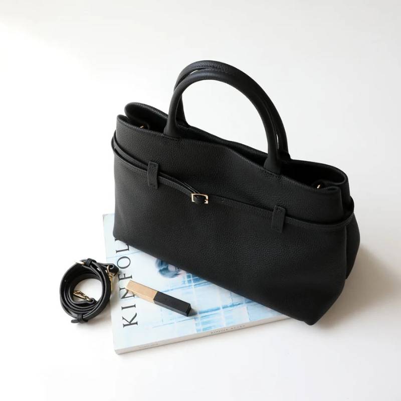 minimalist leather tote bag used for everyday essentials in black color 