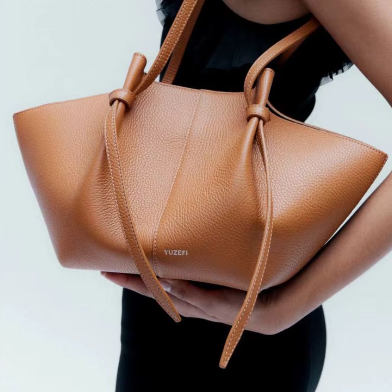 oversized slouchy leather tote bag camel worn on shoulder modern style