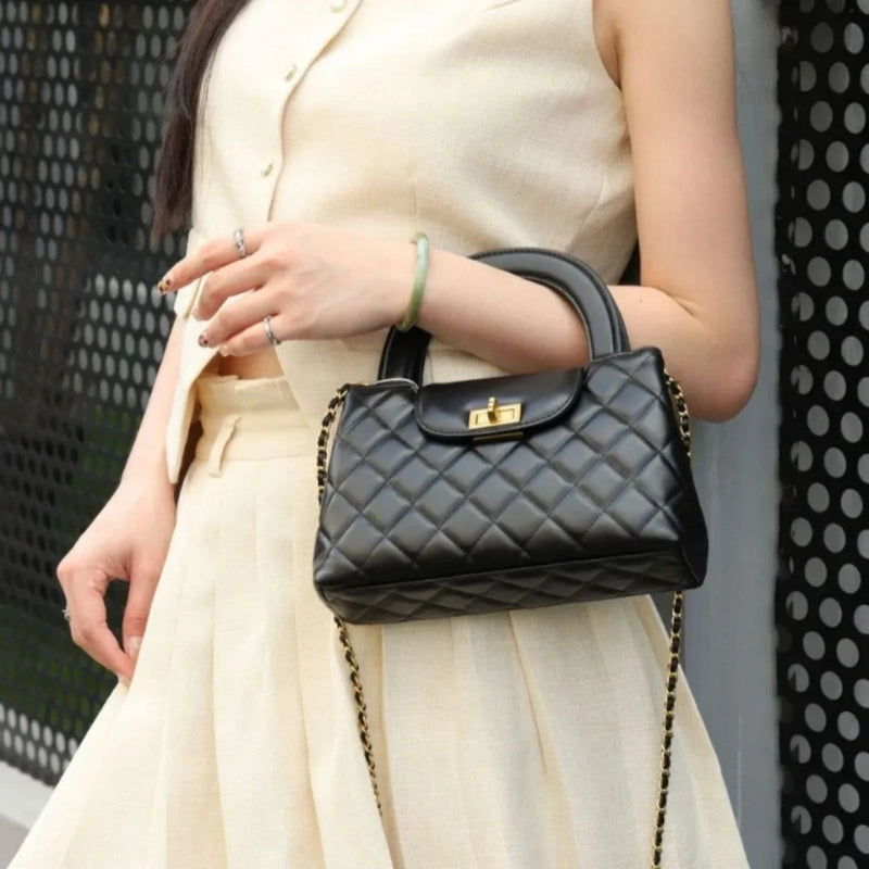quilted mini top handle bag with chain strap worn crossbody outfit