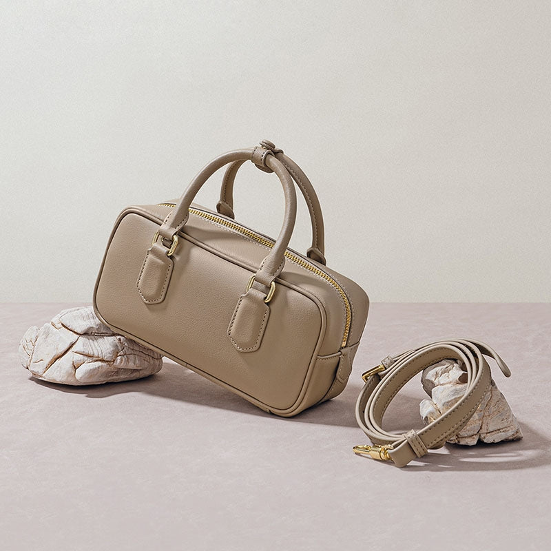 small leather handbag with zipper side view beige bag with shoulder strap minimalist design