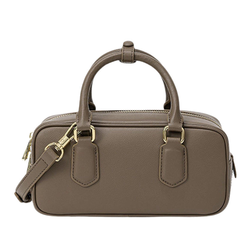 structured small leather handbag beige color side profile compact zip bag