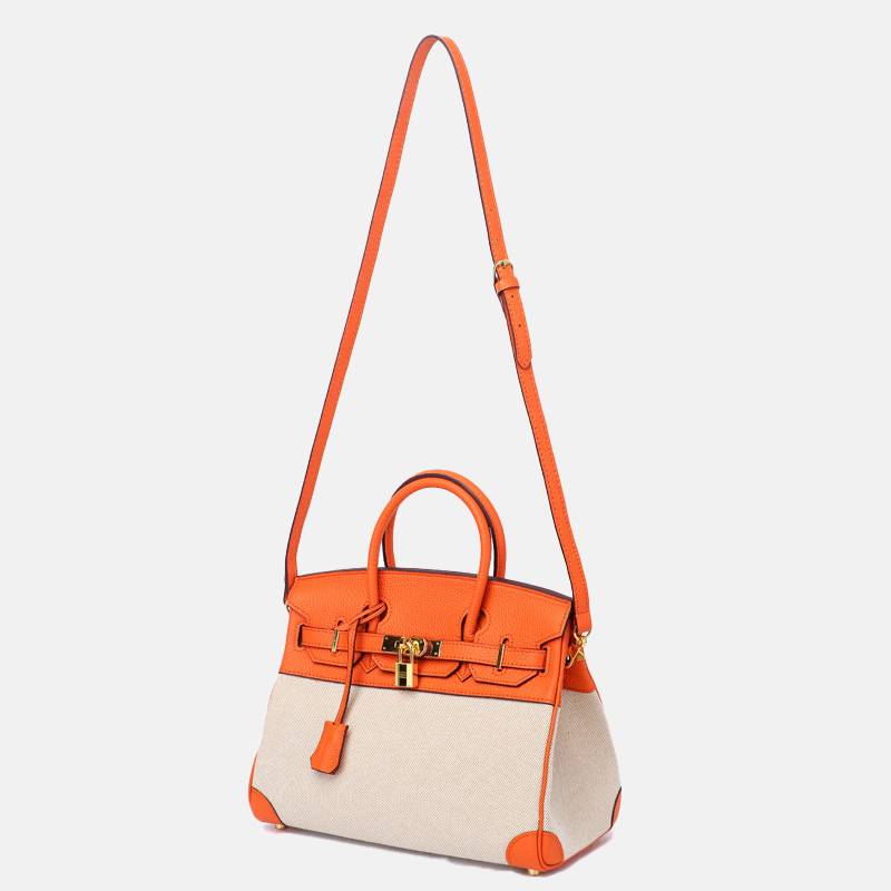 structured top handle bag on shoulder showing compact structured design
