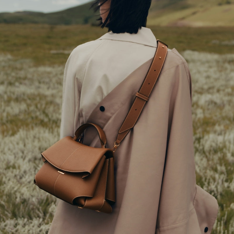 woman wearing fold over leather bag crossbody in everyday outfit